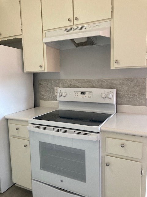 A white oven with a glass door is in a kitchen.