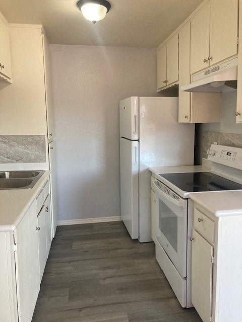 A kitchen with white appliances and cabinets.