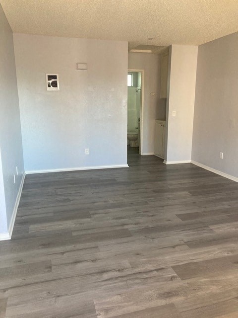 an empty living room with a wood floor