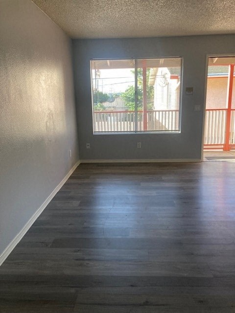 A room with a sliding glass door leading to a balcony.