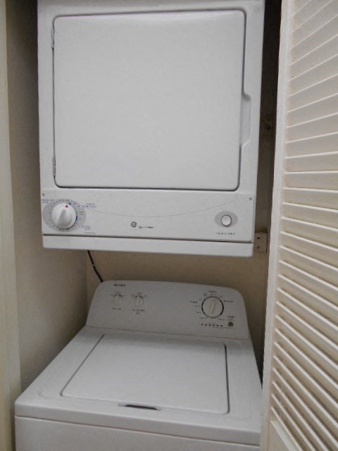 A white washing machine and dryer in a small space.