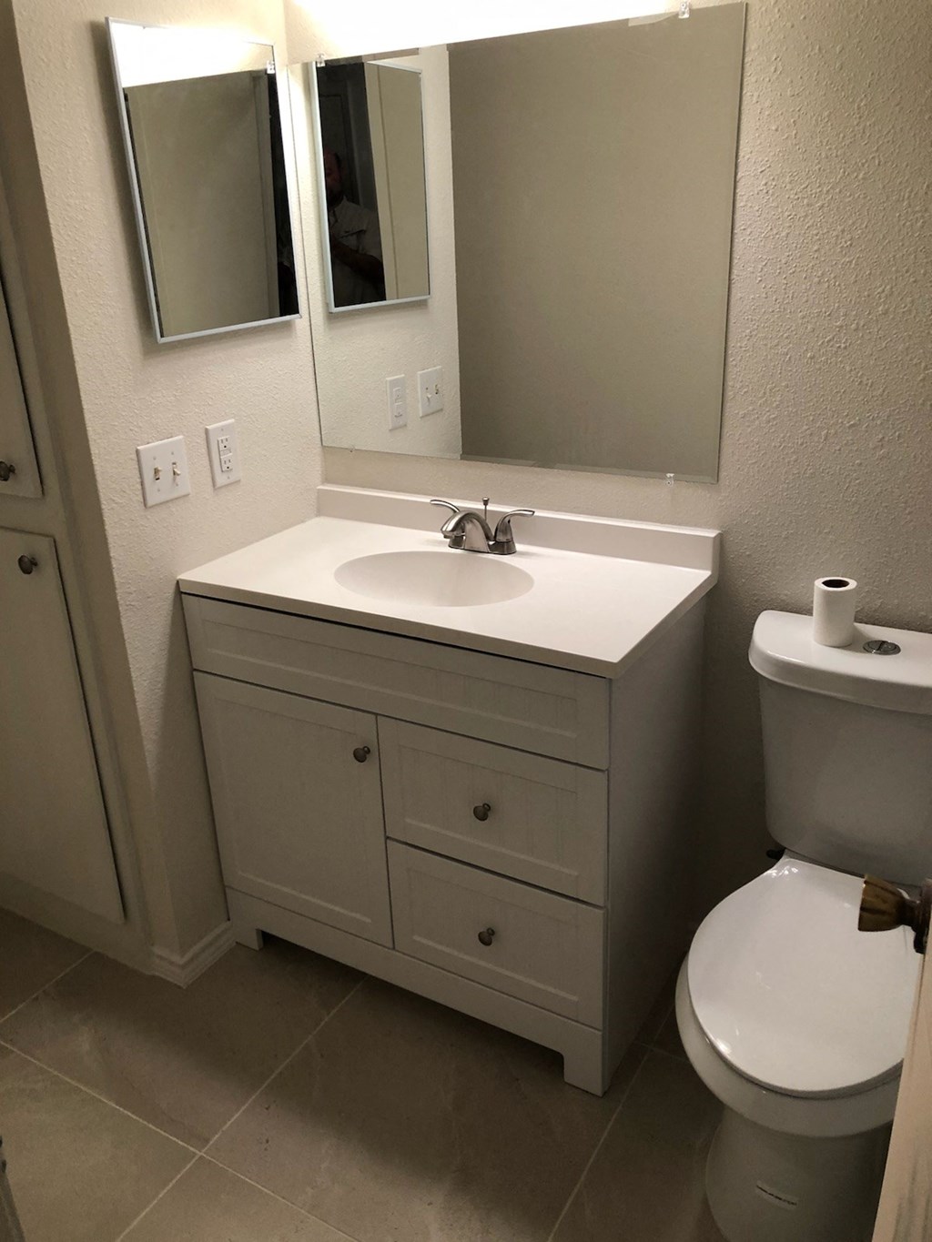 a bathroom with a sink toilet and mirror