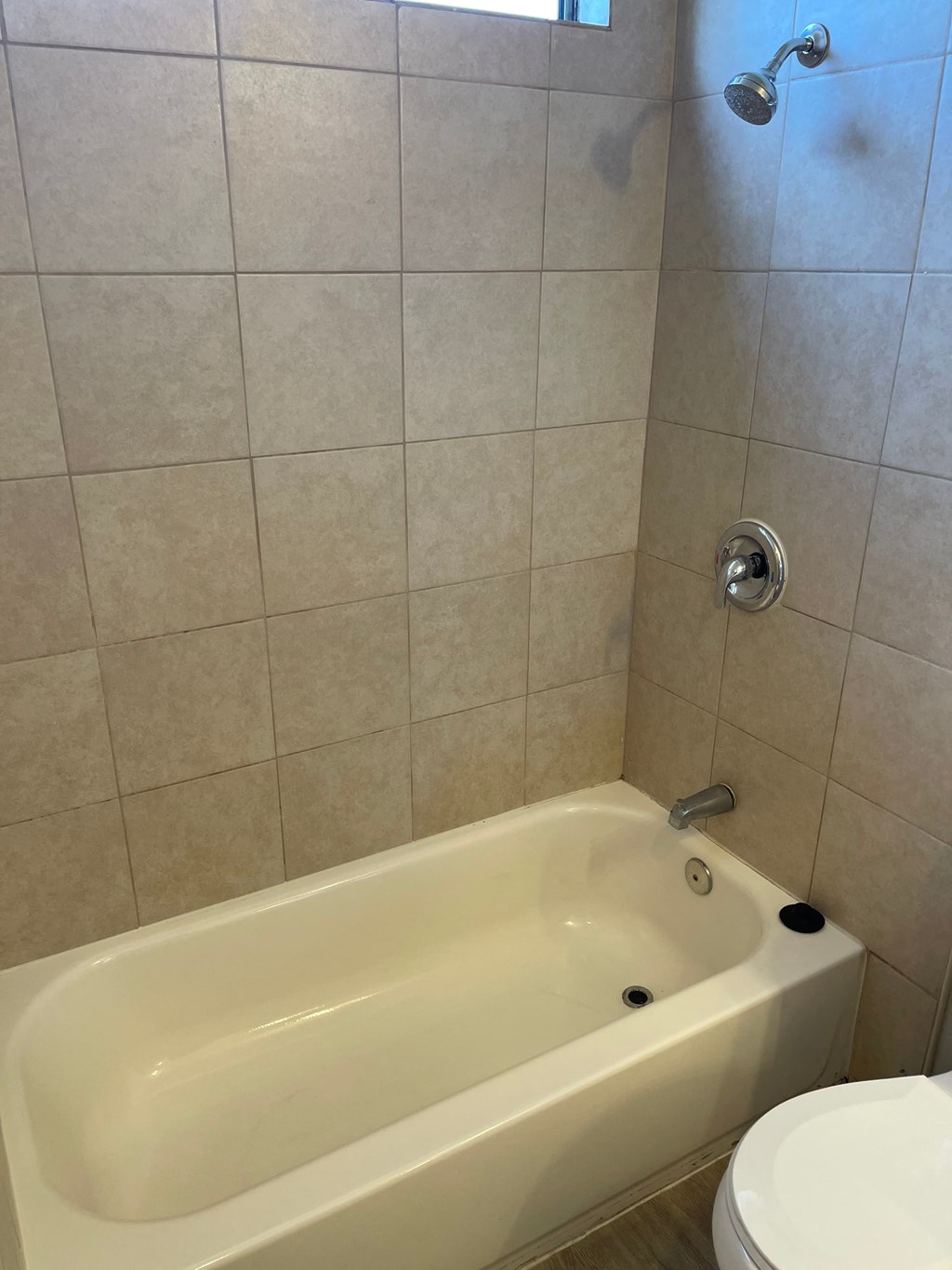 a bathroom with a white tub and a toilet