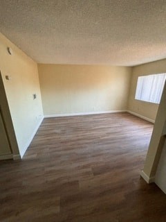 A room with wooden flooring and a window.