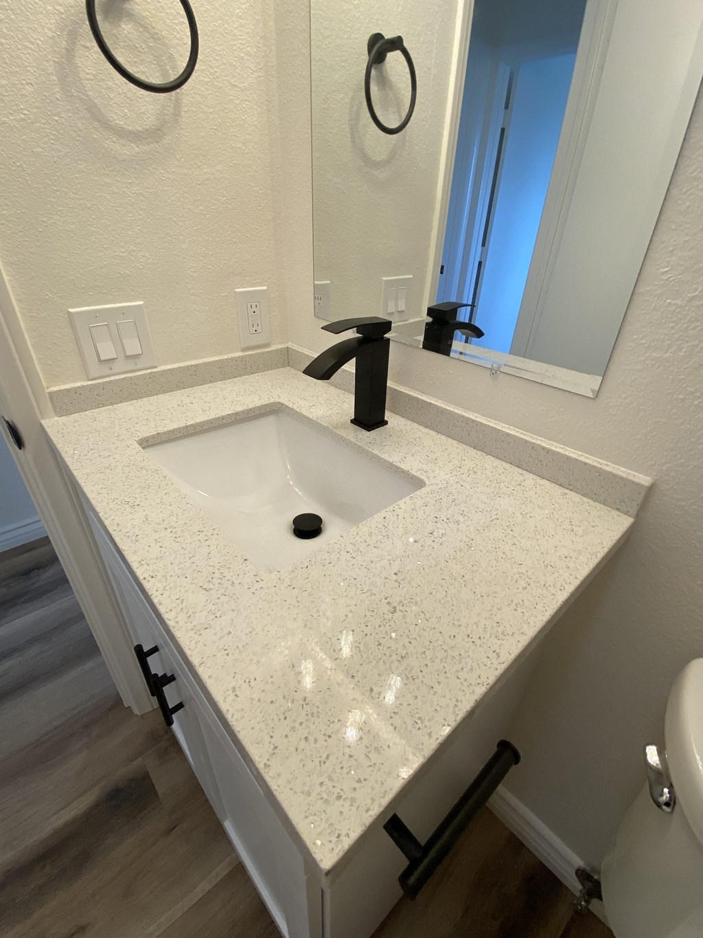 a white counter top in a bathroom with a sink