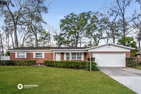 a brick house with a lawn and a white garage door