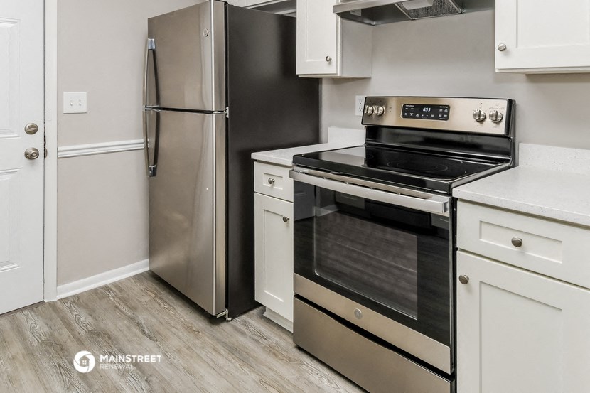 a kitchen with stainless steel appliances and white cabinets