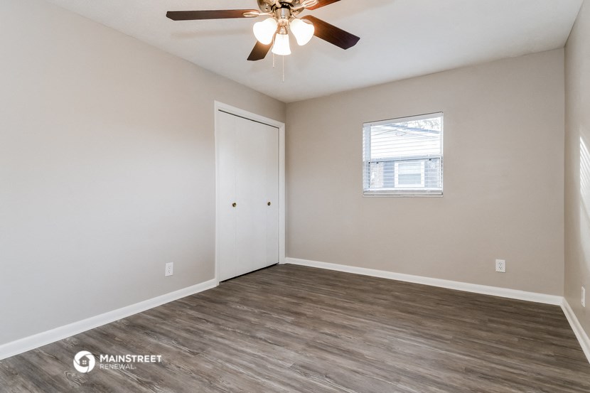 the living room of our studio apartment atrium with a ceiling fan