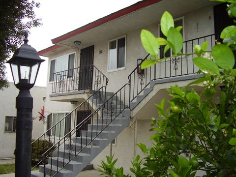 an apartment building with stairs and a lamp post