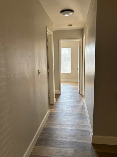 A long hallway with a door at the end.