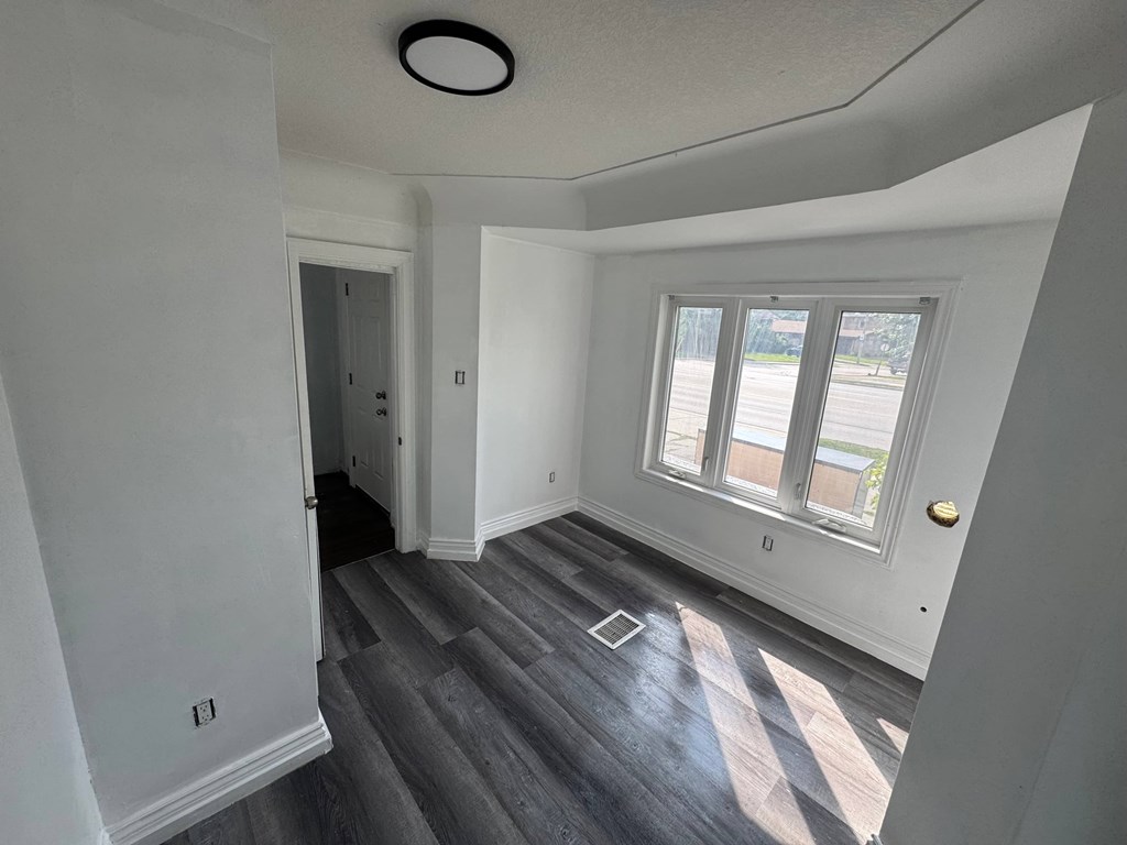 A room with a grey floor and white walls.