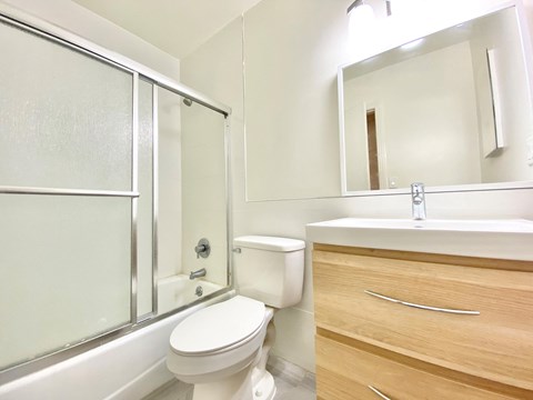 a bathroom with a toilet and a sink and a shower
