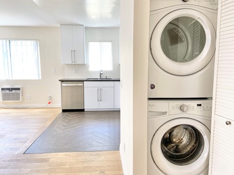 a washer and dryer in a laundry room next to a kitchen