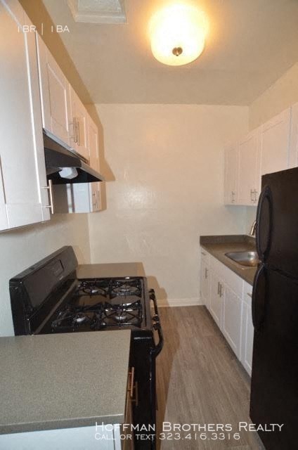 a kitchen with a black stove and a black refrigerator