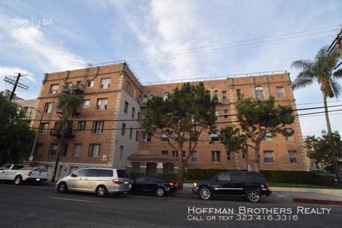 a large building with cars parked in a parking lot