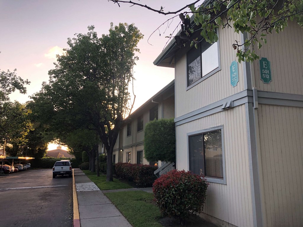 a street view of a building with a car parked in front of it