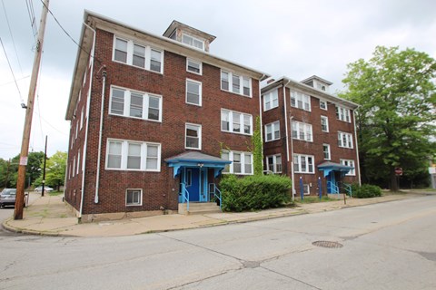 A red brick building with blue doors and windows.