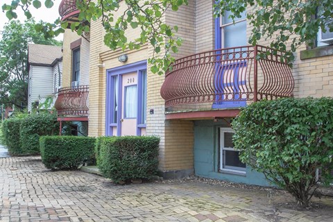 A building with a blue door and a red balcony.