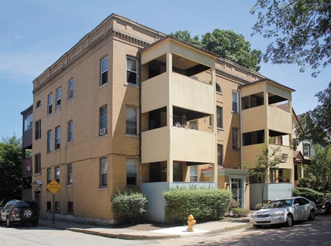 a brick apartment building with a yellow fire hydrant