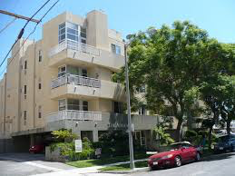 a red car parked in front of a building