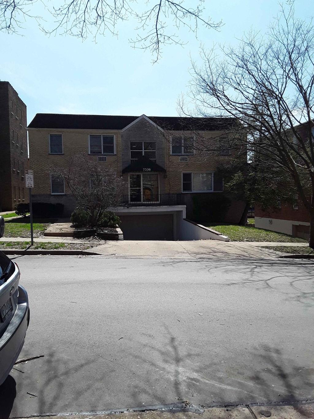 a large brick house with a driveway in front of it