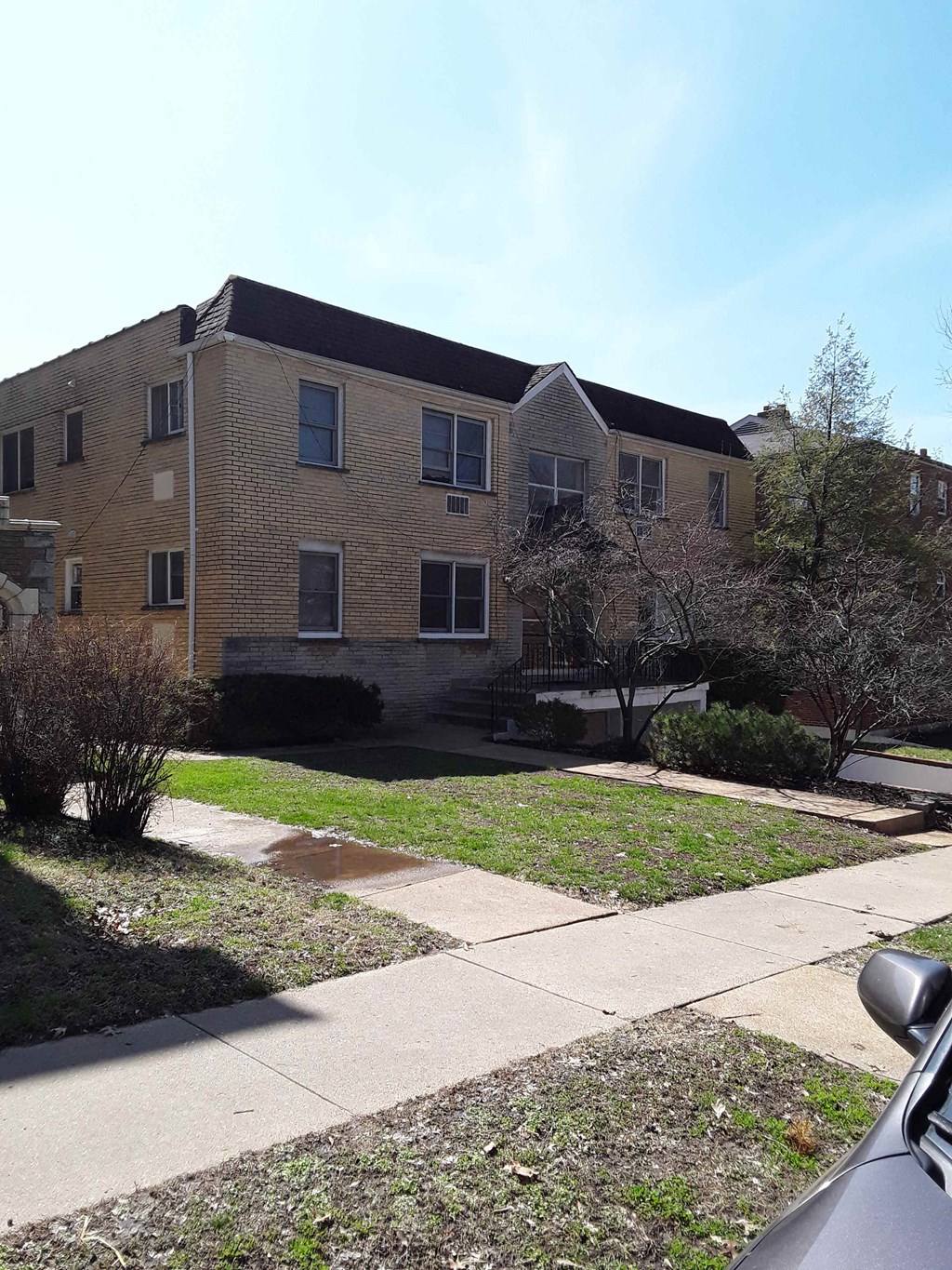 a brick building with a sidewalk in front of it