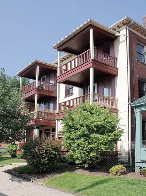 A building with a red brick facade and a balcony.