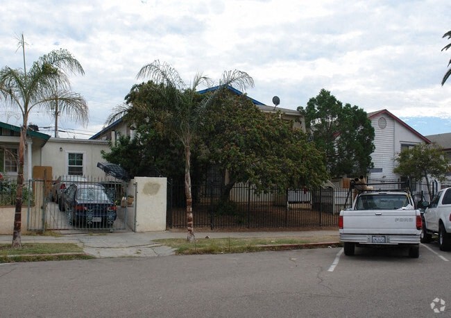 a white truck parked in a parking lot in front of a house