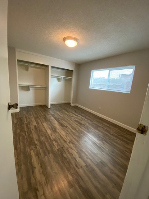 A room with a window and a wooden floor.