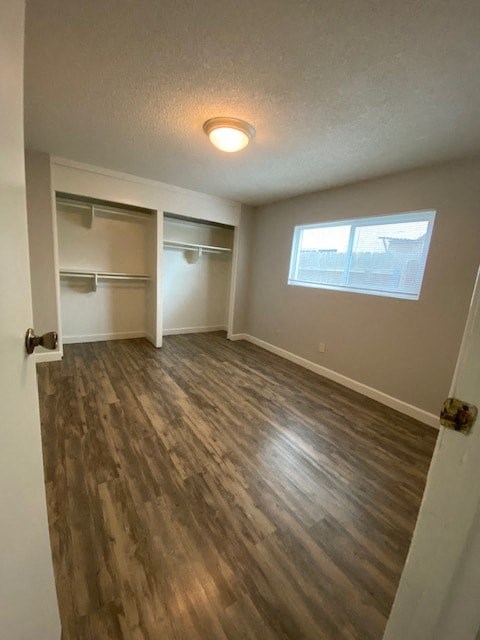 A room with a window and a wooden floor.