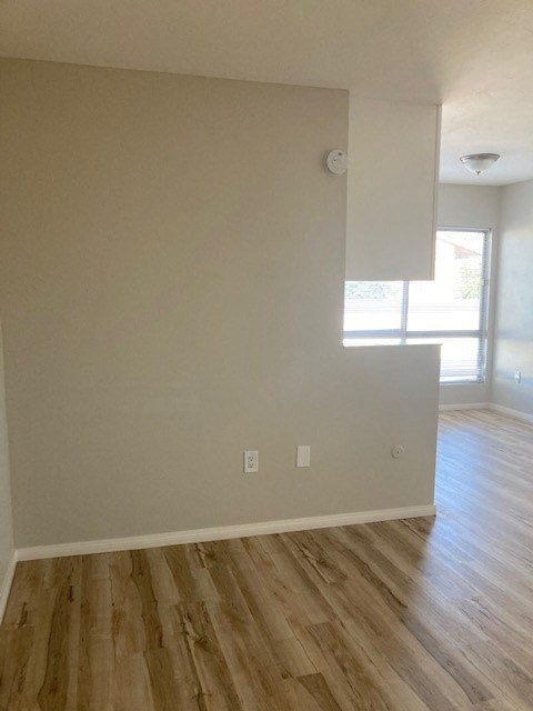 an empty living room with a hard wood floor