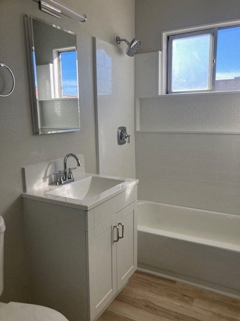 a white bathroom with a sink and a bath tub