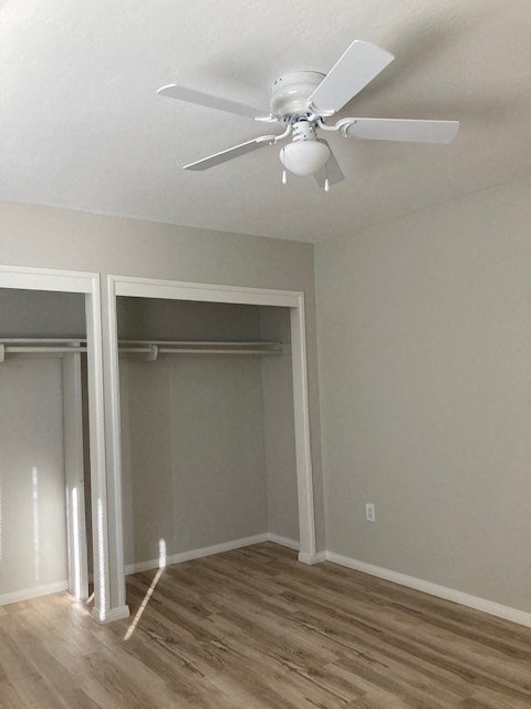 a room with a ceiling fan and a closet