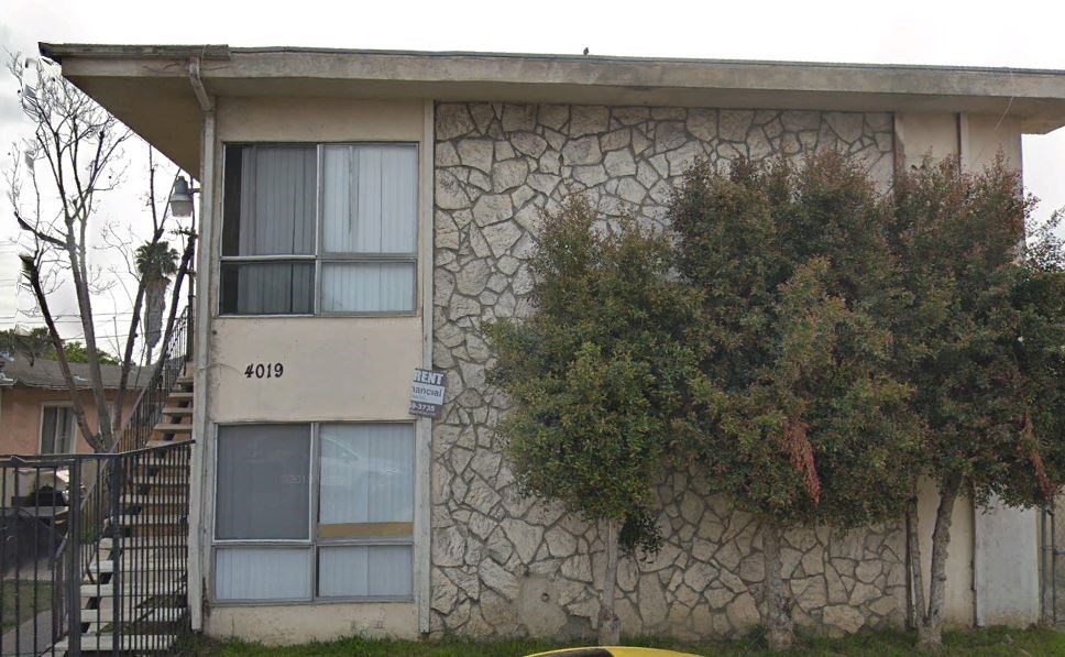 a stone building with a tree in front of it