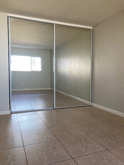 an empty living room with sliding glass doors