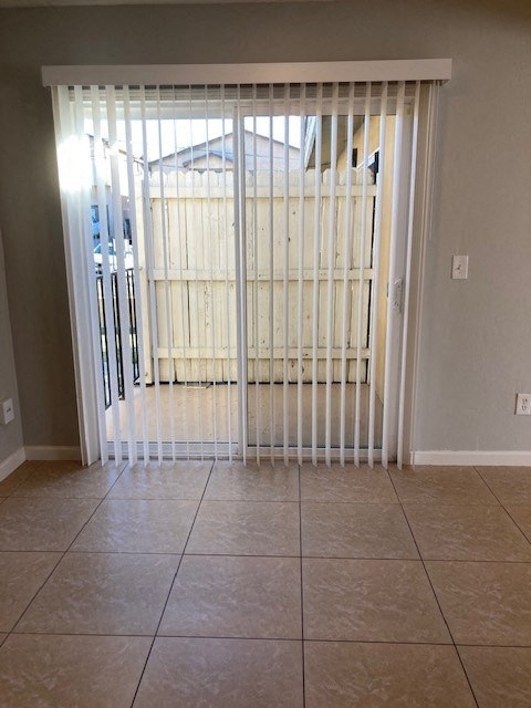 an empty living room with a sliding glass door