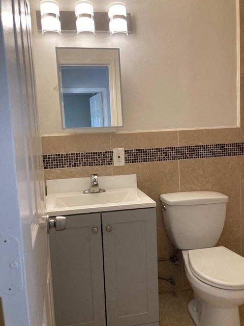 a bathroom with a toilet sink and a mirror