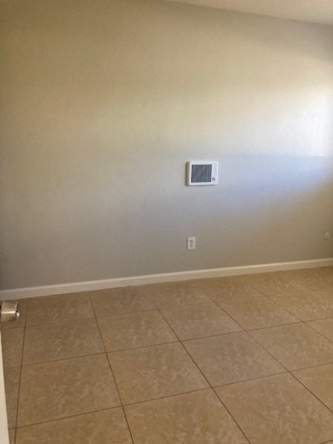 an empty room with a heater on the wall
