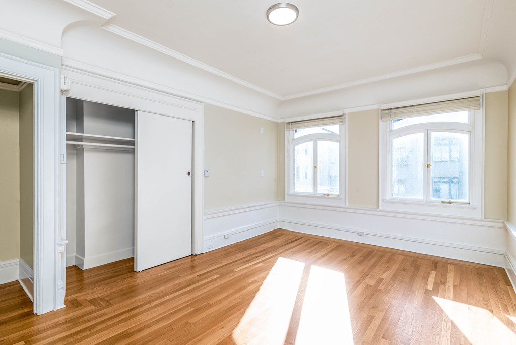 A room with wooden floors and white walls.