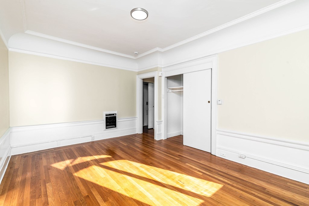 A room with a wooden floor and a white ceiling.
