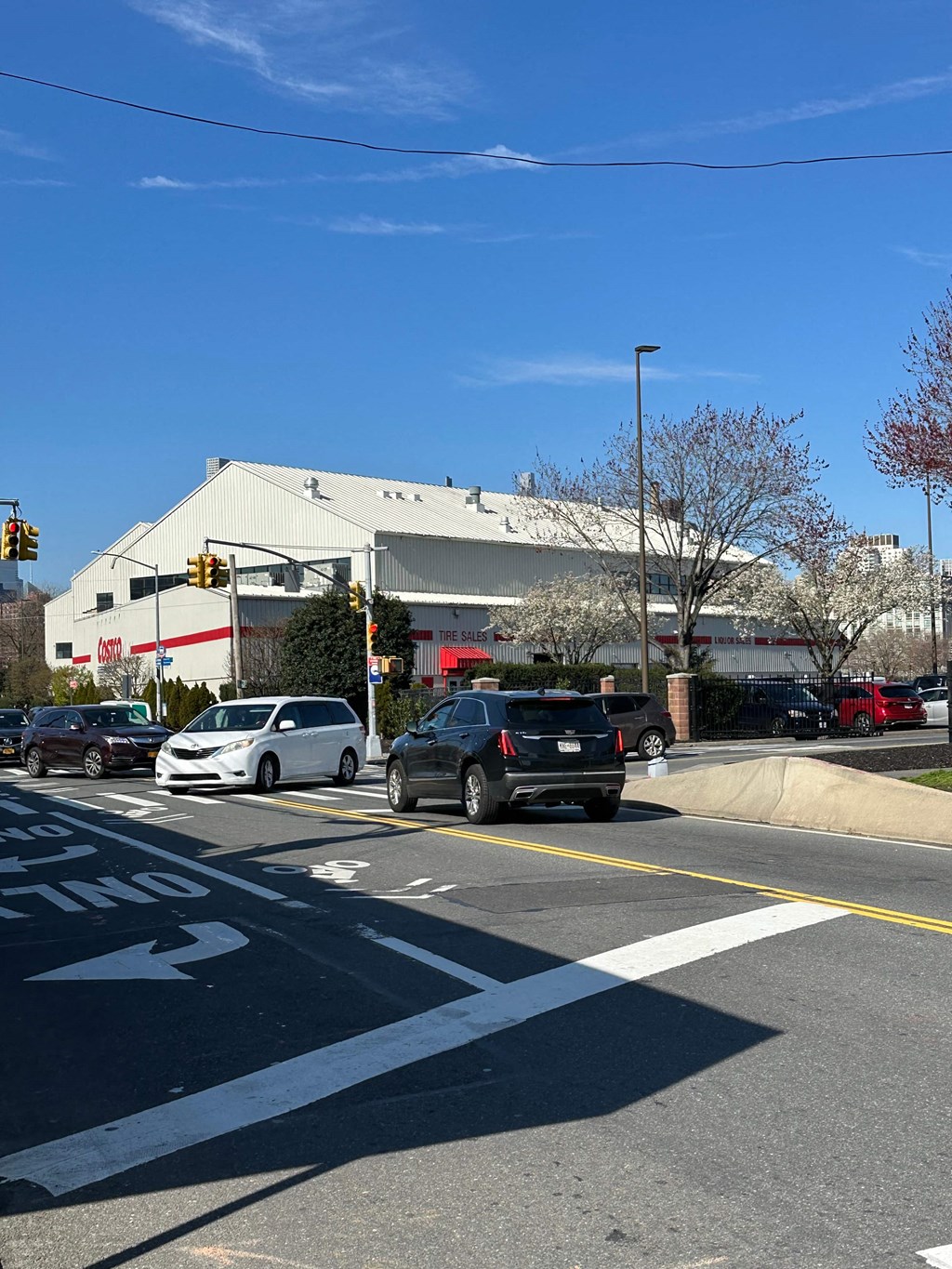 a busy city street with cars parked in front of a building
