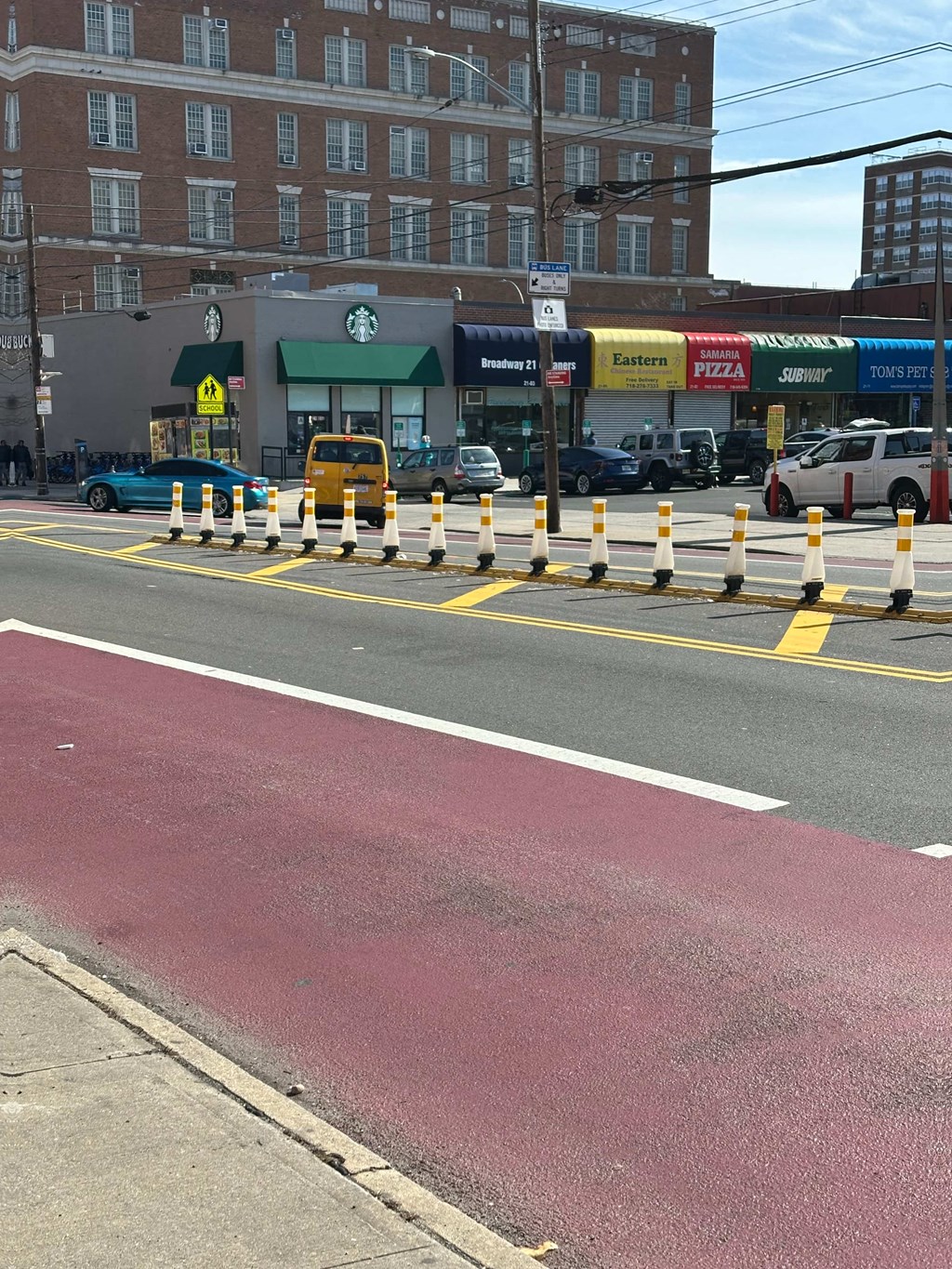 a street with yellow and white dividers in the middle of it
