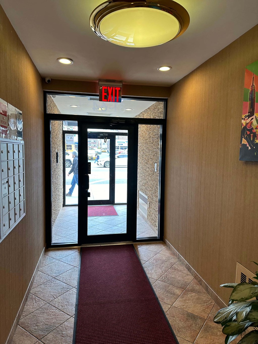 a fire exit sign above a door in a hallway of a building