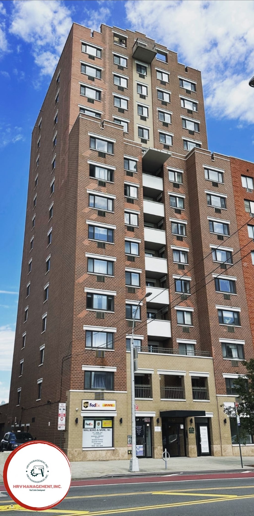a tall brick building with a red circle in front of it