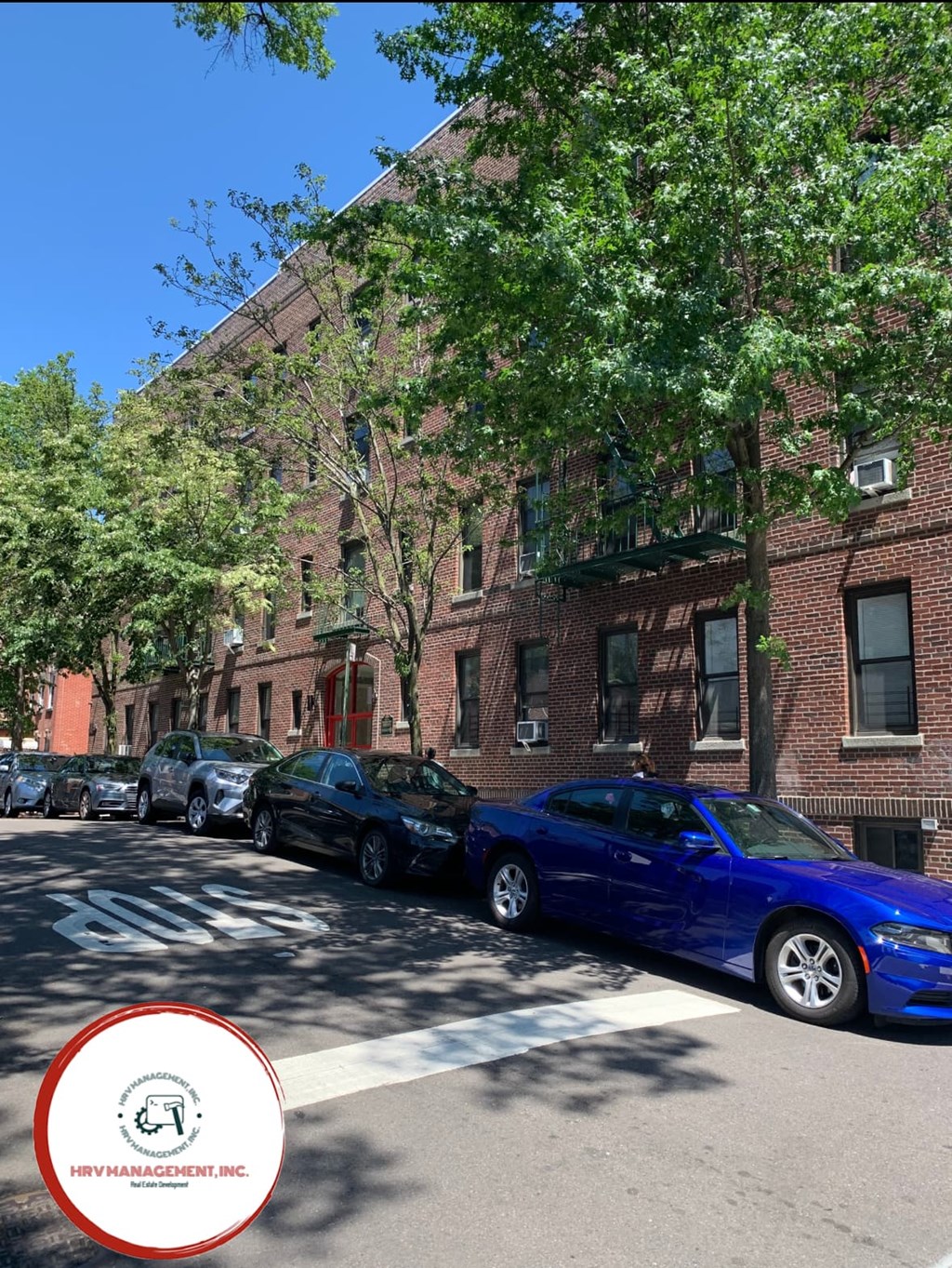 A blue car is parked on the side of a street.