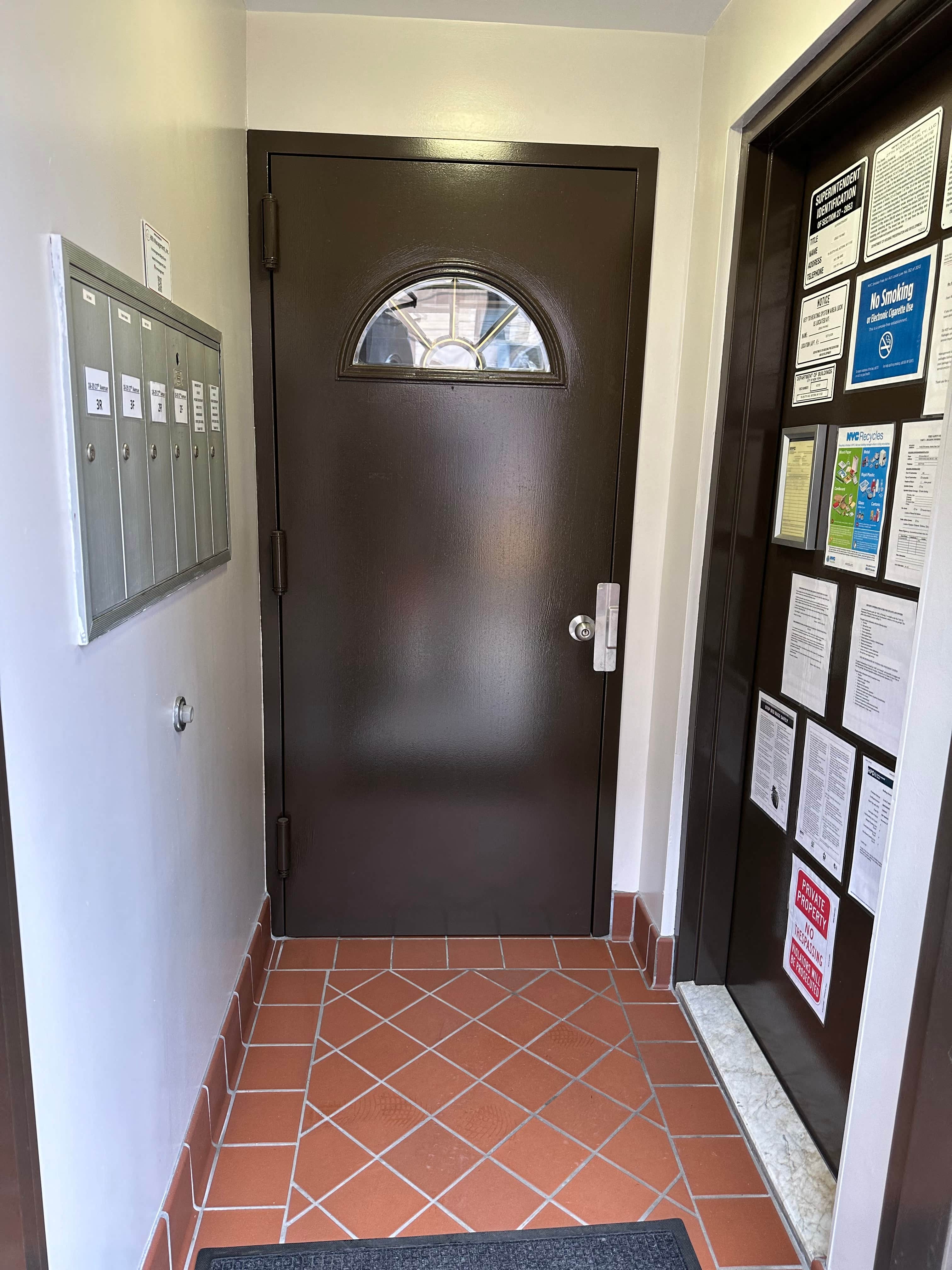 the front door of a building with a tiled floor