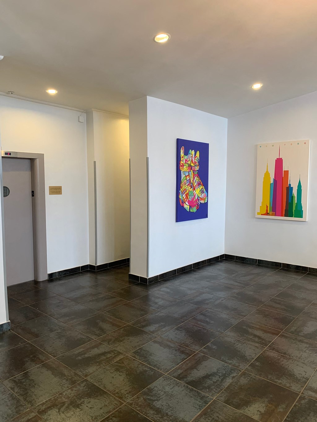 a large room with a painting on the wall and a door