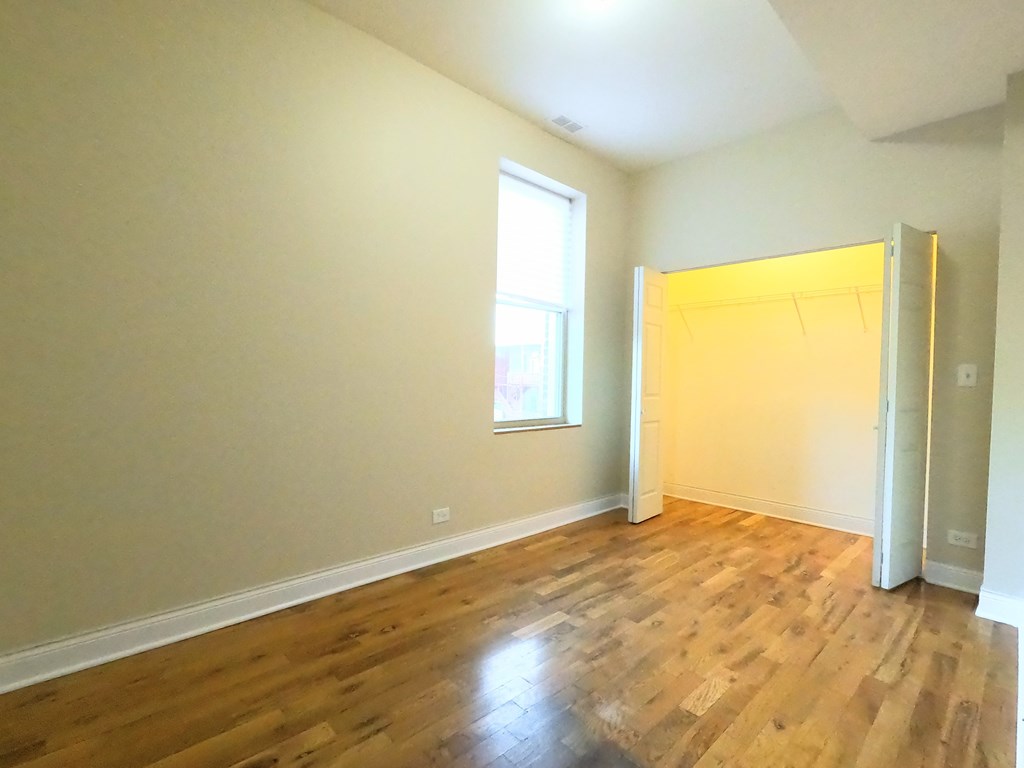 A room with wooden floors and a window.