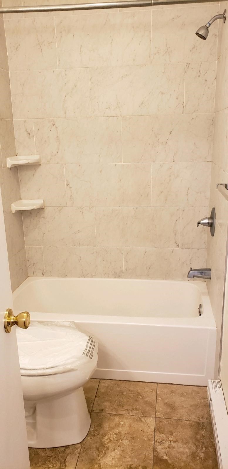 a bathroom with a toilet and a bath tub