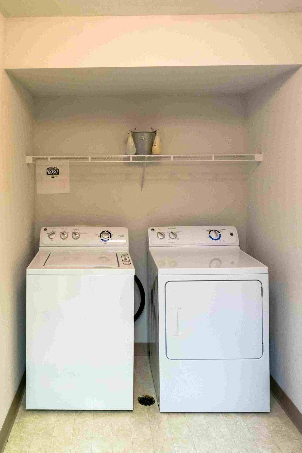 a room with two washes and a dryer in it